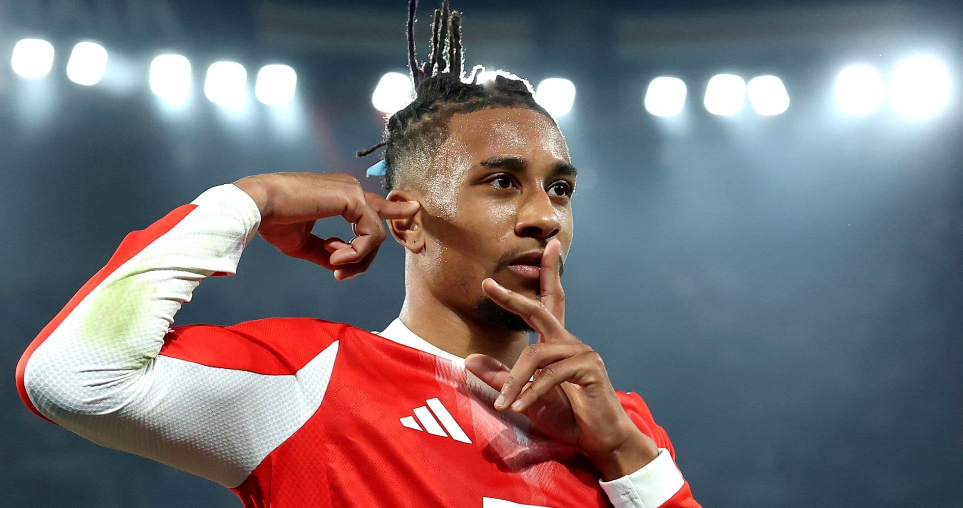 Player celebrating goal with a shushing gesture