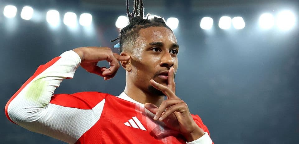 Player celebrating goal with a shushing gesture