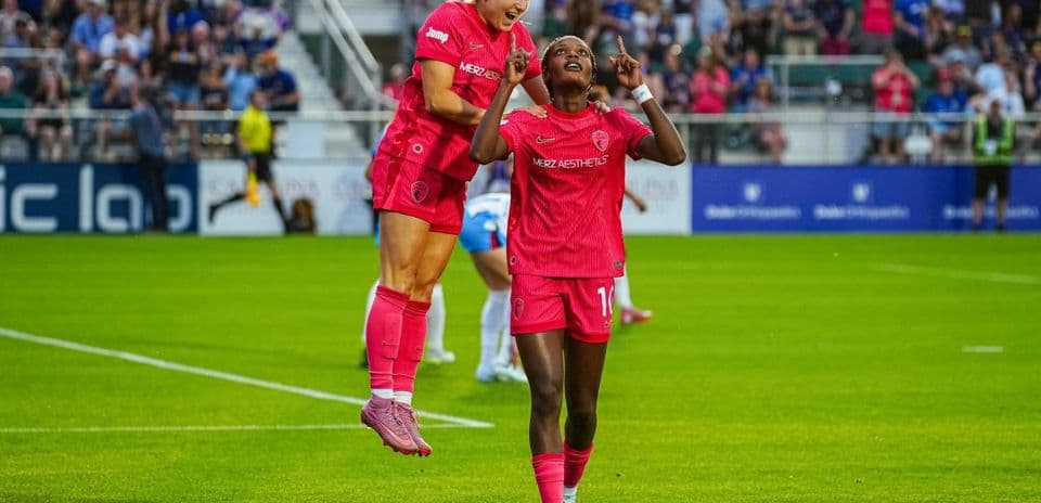 Players celebrating during NWSL match