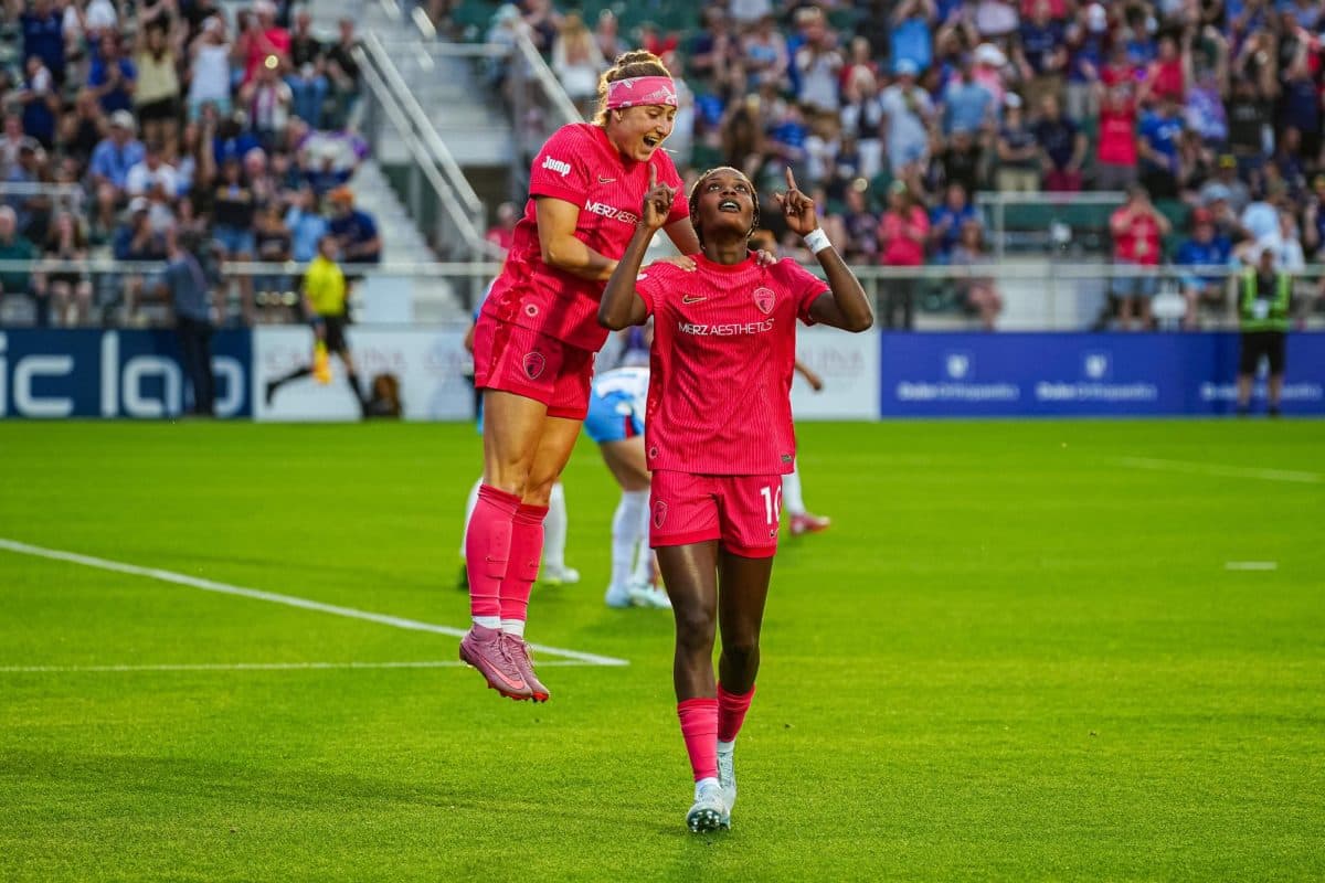 Players celebrating during NWSL match