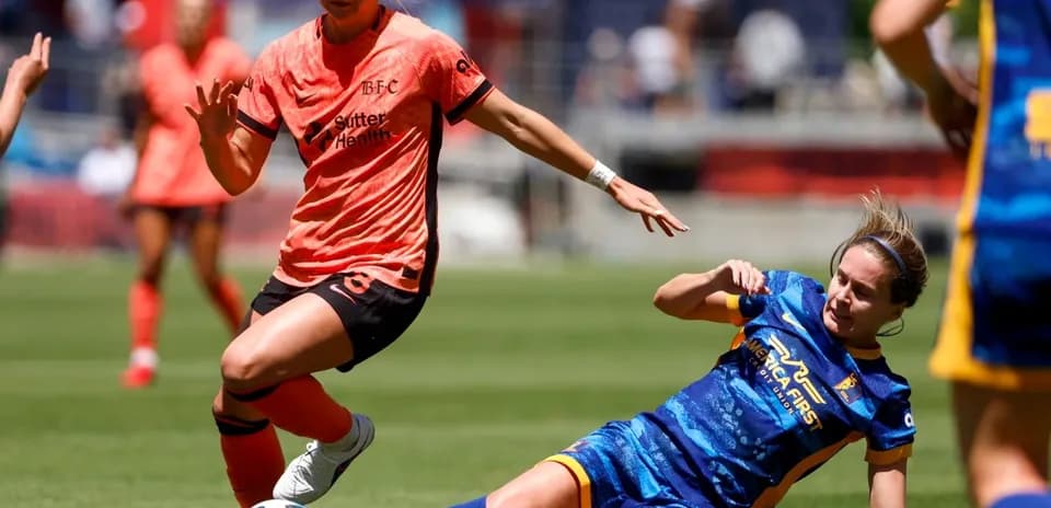 Bay FC player dribbling against Utah Royals defender