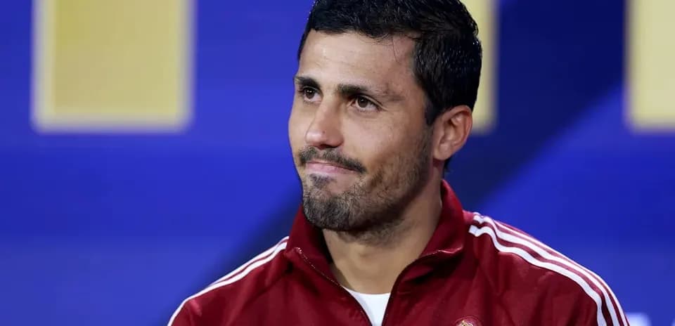 Athlete wearing red jacket at press conference