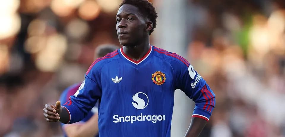 Player in blue Manchester United jersey on field