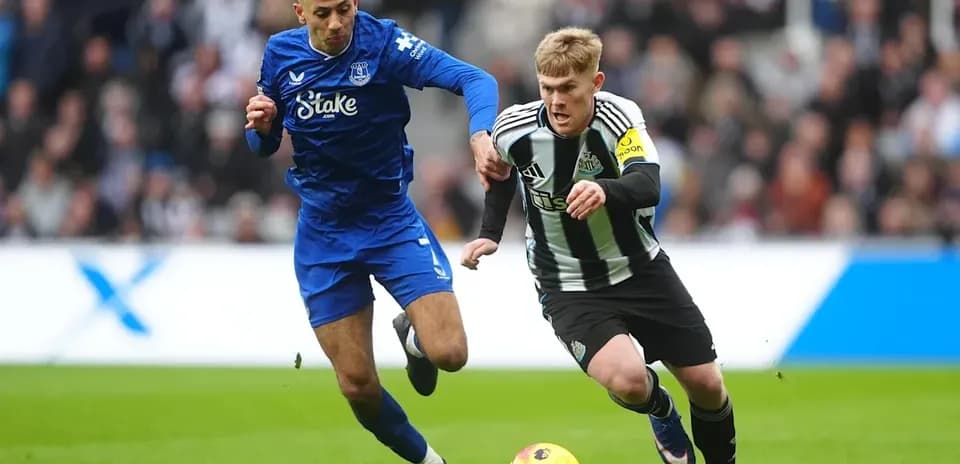 Two players competing for the ball on field