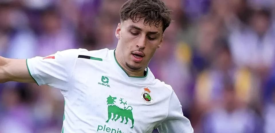 Player in white jersey dribbling the ball during match