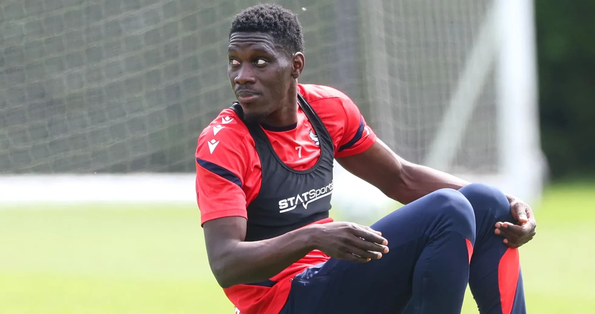 Player stretching during training session on field