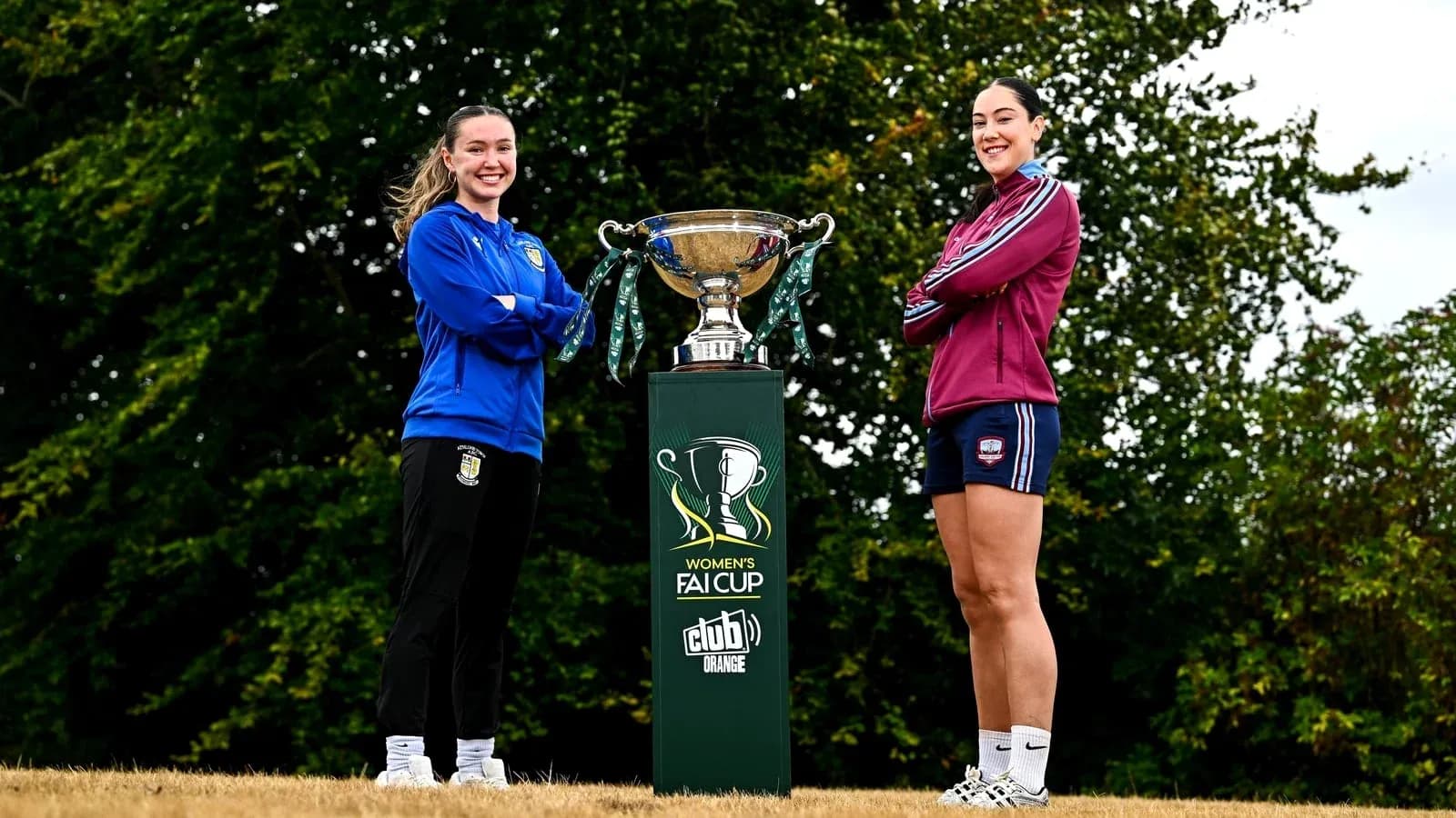 Two players posing with Women's FAI Cup trophy