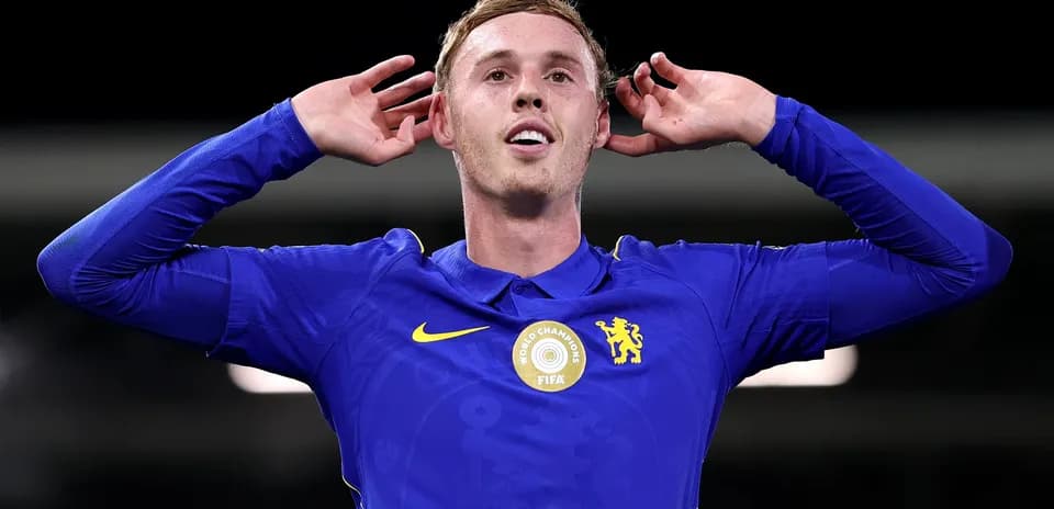Player celebrating with hands behind ears in blue jersey
