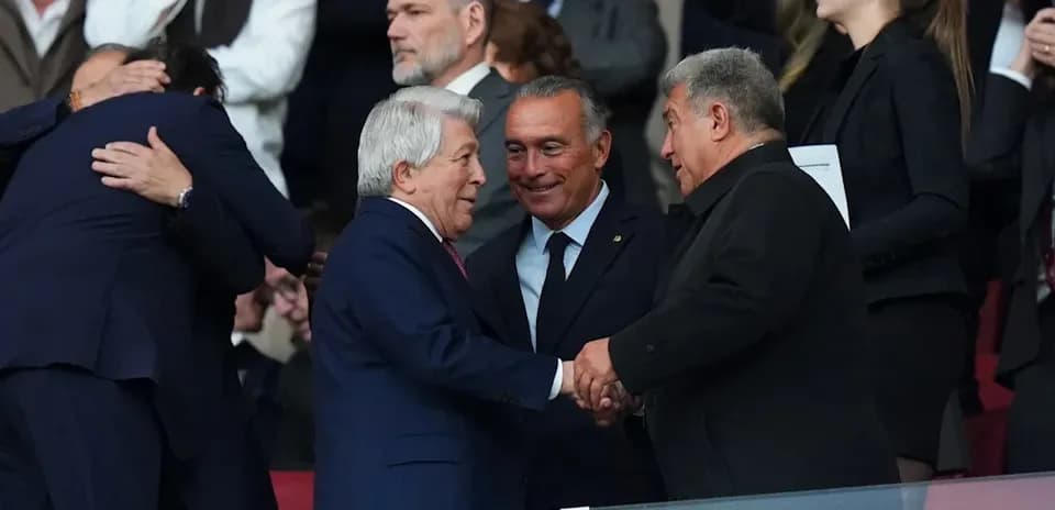 Three men shaking hands in a stadium box