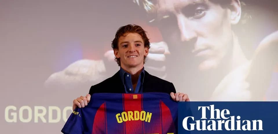 Player holding Barcelona jersey at press conference