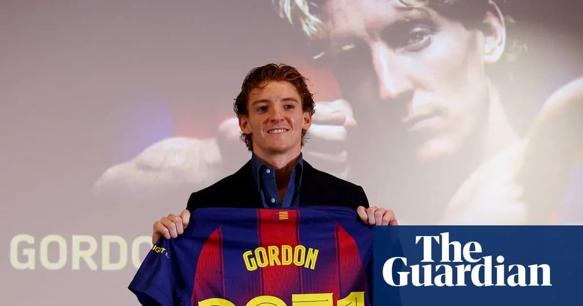 Player holding Barcelona jersey at press conference