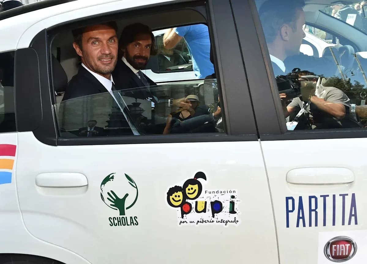 Two men in formal attire inside a car