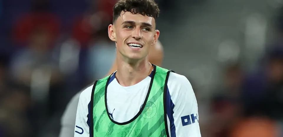 Player wearing training bib smiling on the field