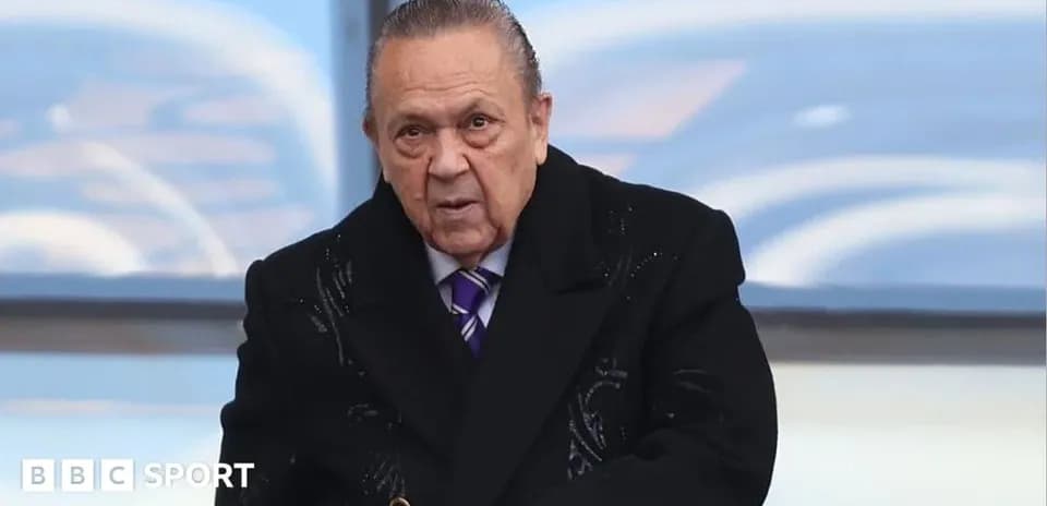 Man in formal attire at sporting event