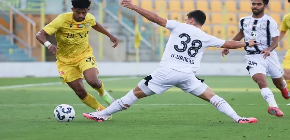 Player dribbling past opponent during U23 match