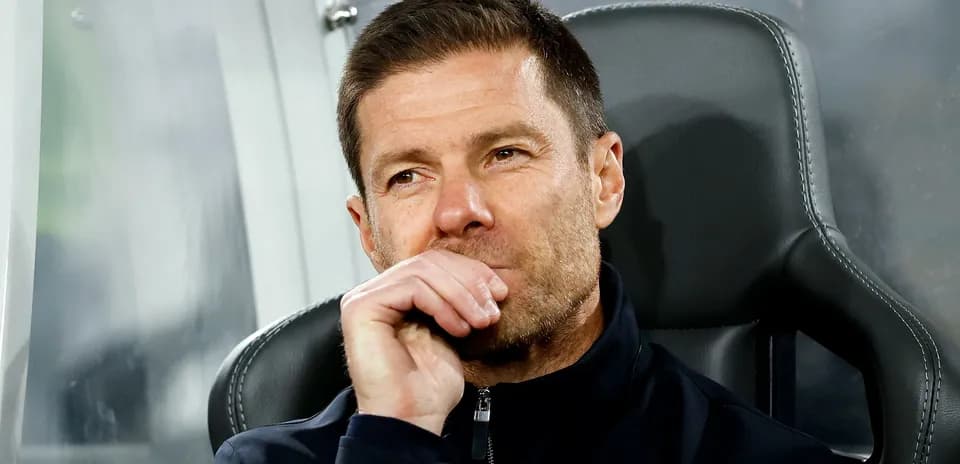 Coach seated on bench during a match
