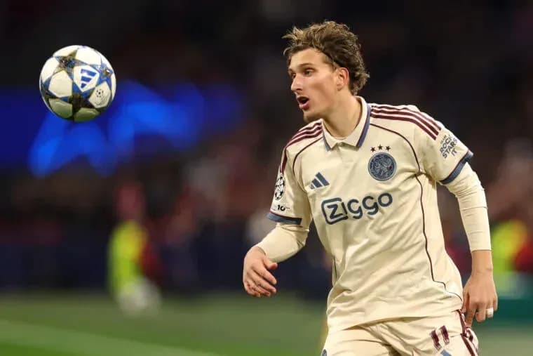Player in Ajax jersey controlling a soccer ball