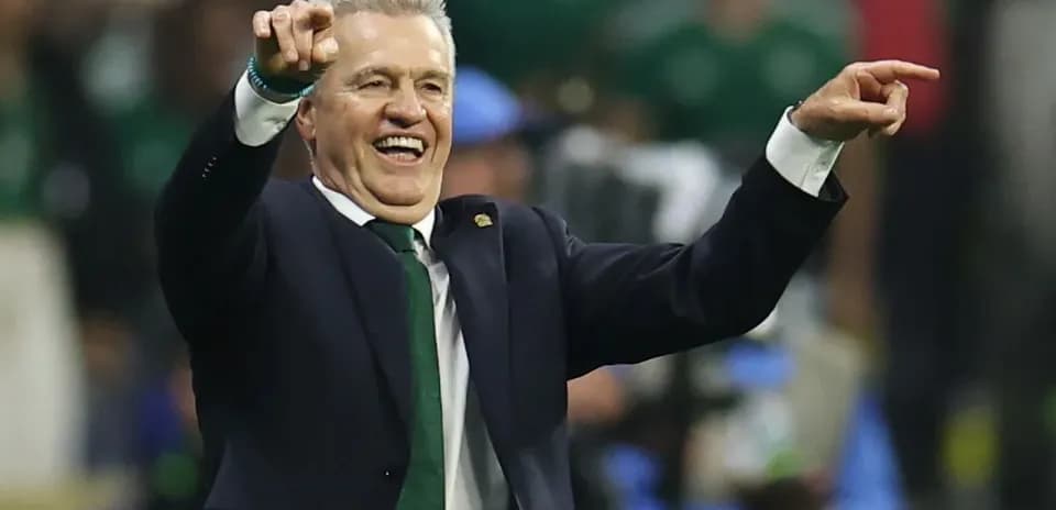 Coach celebrating and pointing during a match