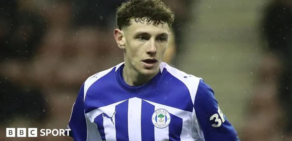 Player wearing Wigan Athletic kit during match