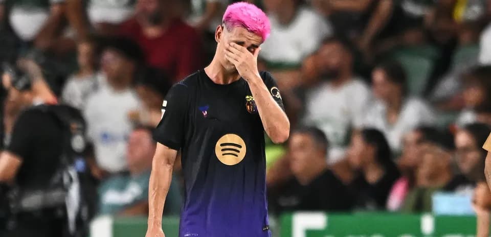 Player with pink hair walking off field, distressed