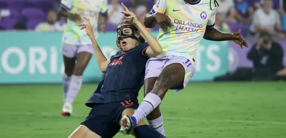 Player tackling opponent during NWSL match