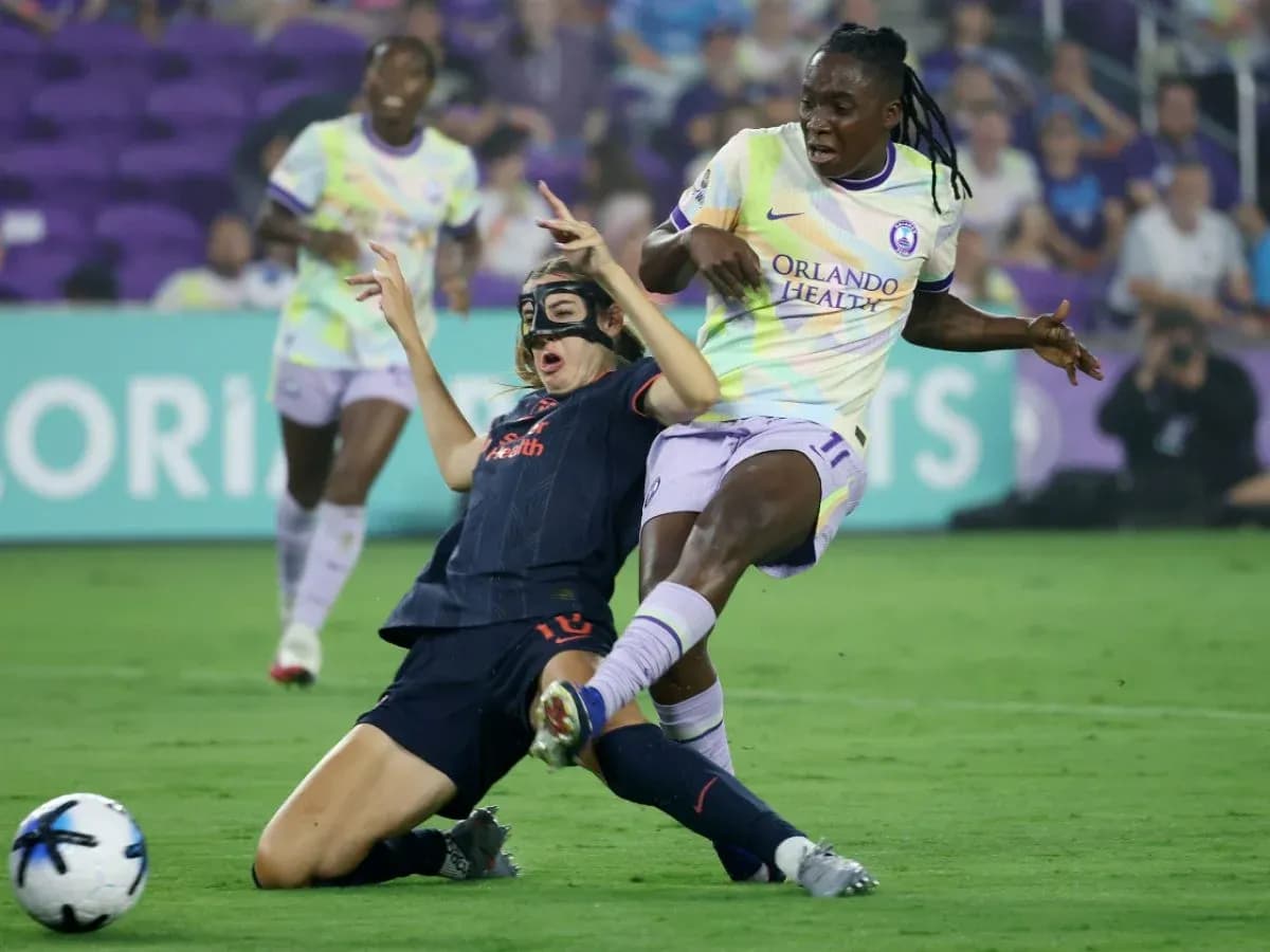 Player tackling opponent during NWSL match