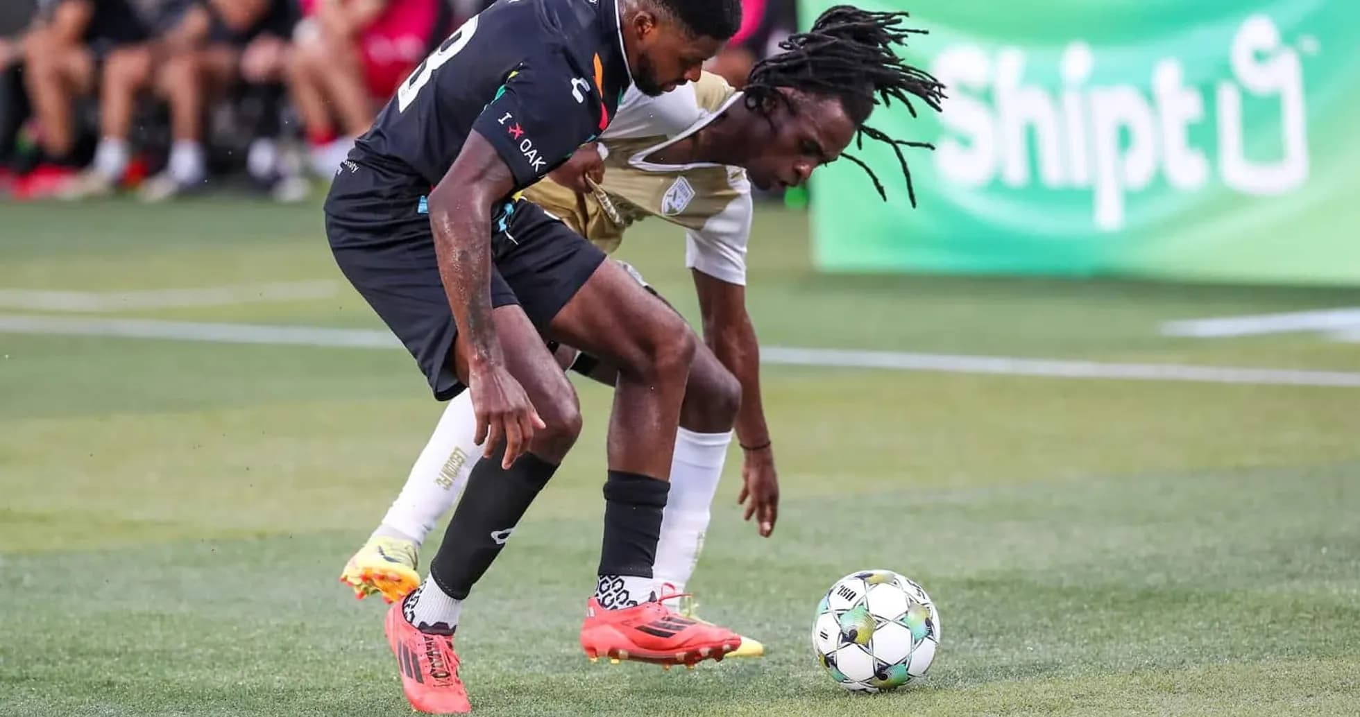 Two players competing for the ball during match