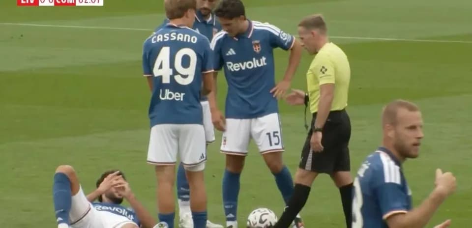 Players gathered around injured teammate on field
