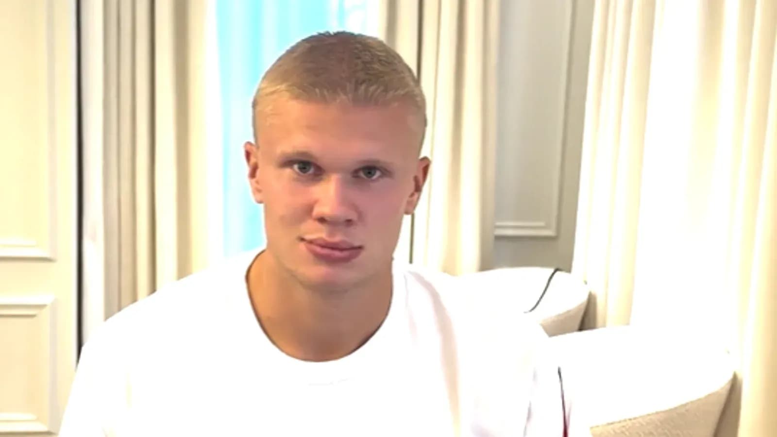 Player sitting in a room with curtains