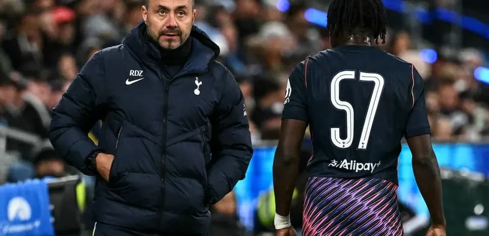 Tottenham manager interacting with player on sideline