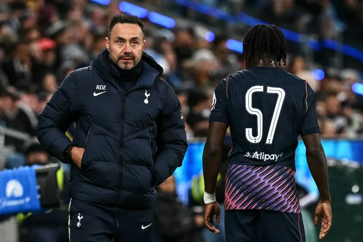 Tottenham manager interacting with player on sideline