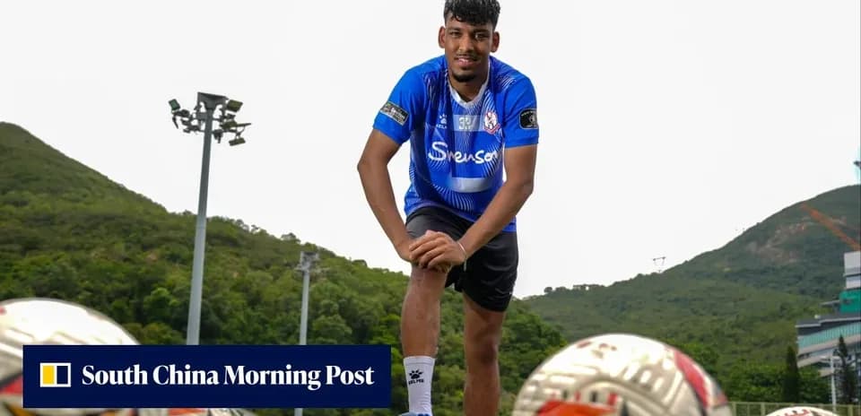 Football player posing with training balls outdoors