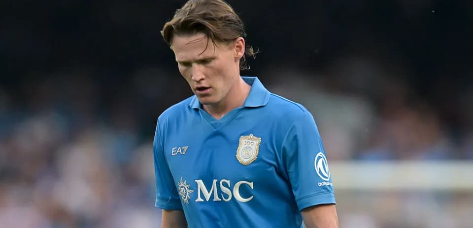 Player in blue jersey walking with head down