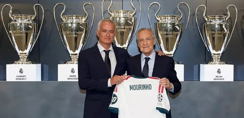 Jose Mourinho presenting jersey with trophies in background
