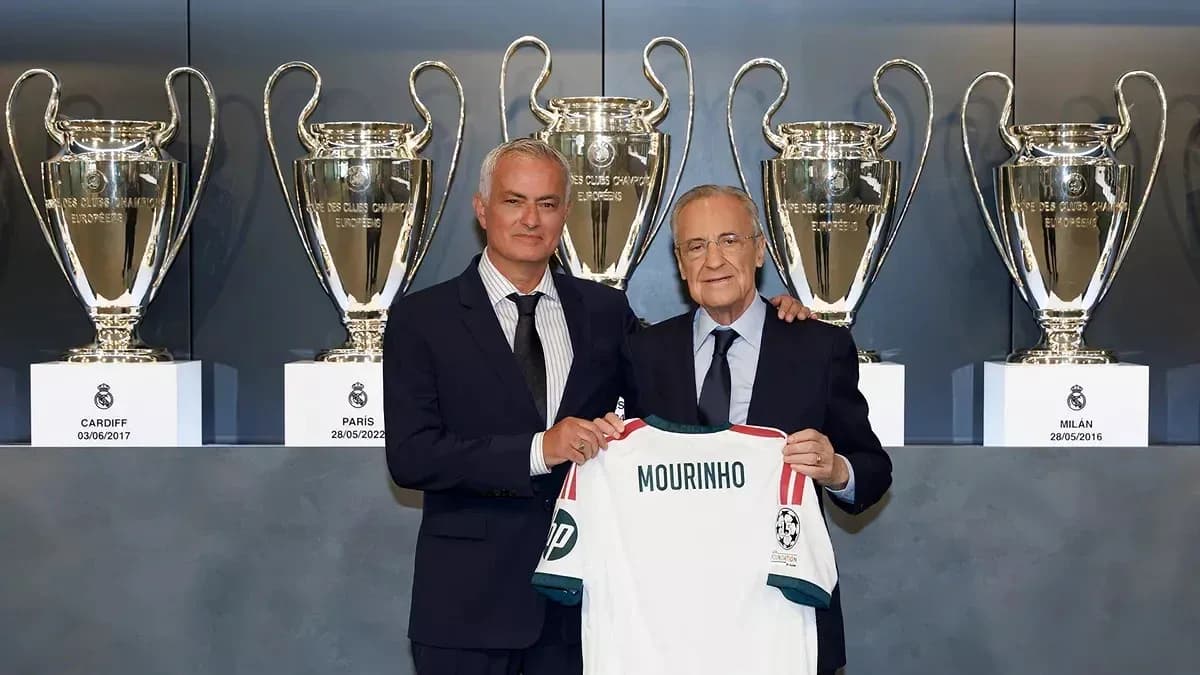 Jose Mourinho presenting jersey with trophies in background