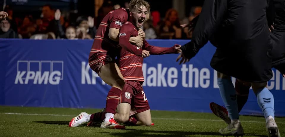 Players celebrating a goal during match