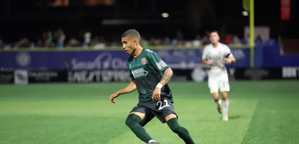 Player dribbling the ball during MLS Next Pro match