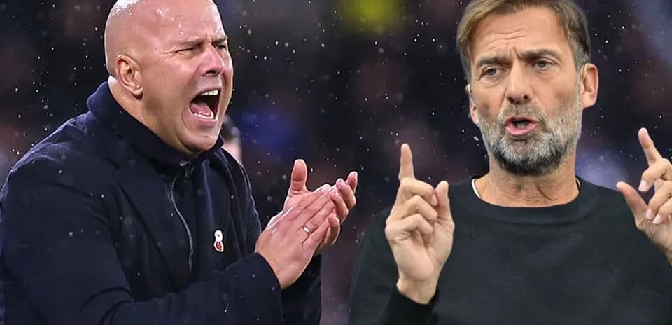 Two football managers discussing tactics during match