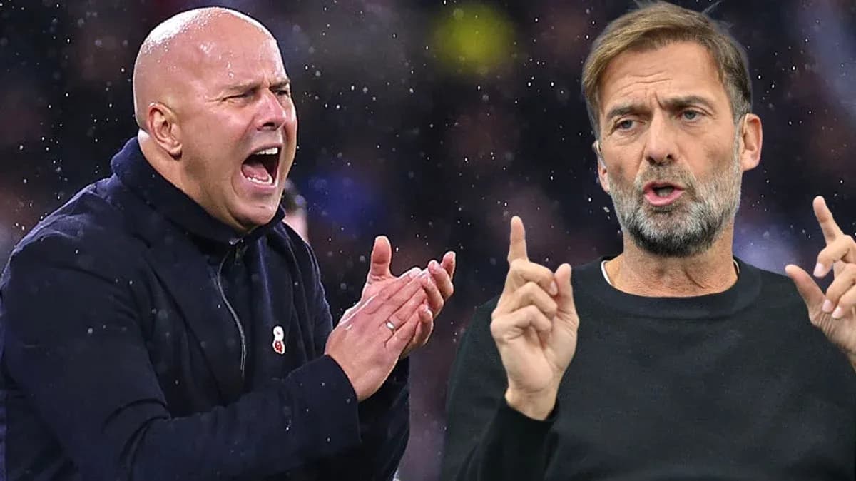 Two football managers discussing tactics during match