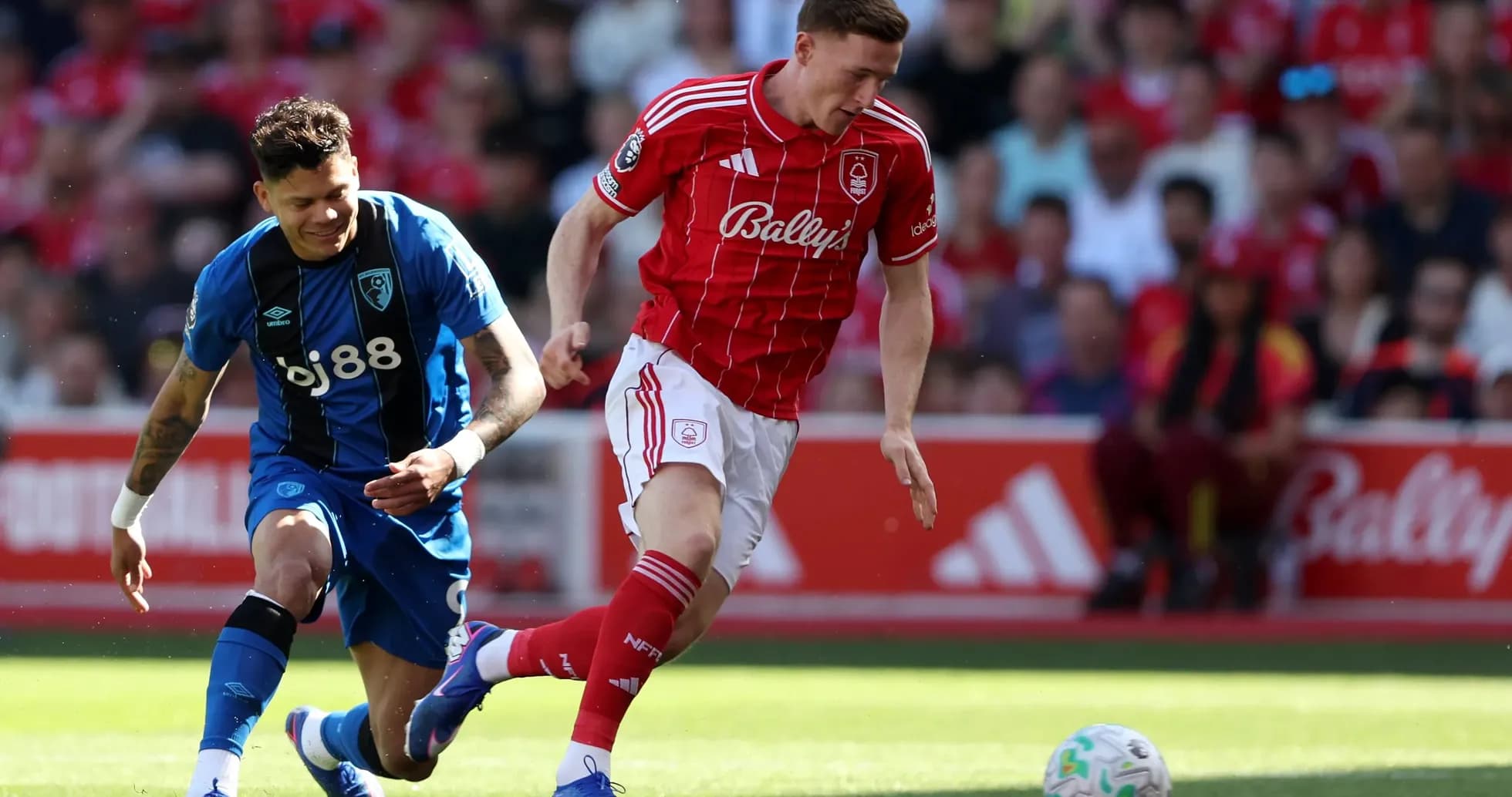 Nottingham Forest player evading Bournemouth defender