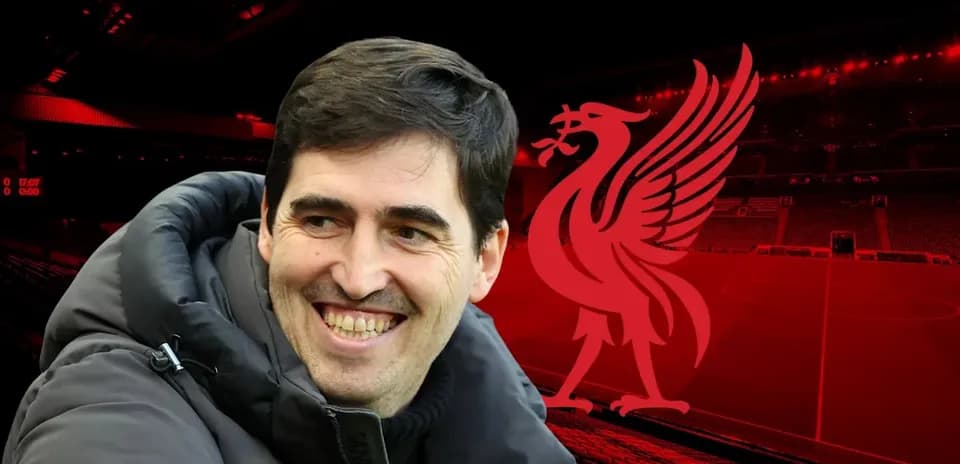 Smiling coach in front of Liverpool stadium backdrop