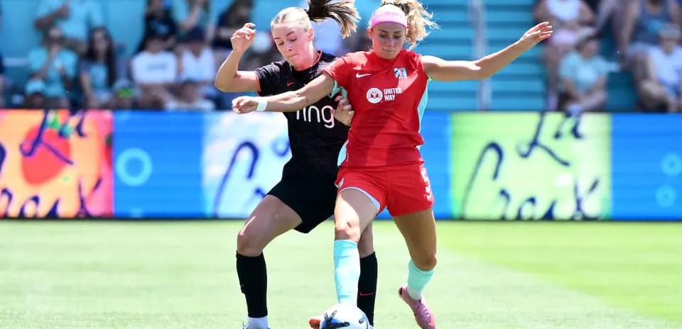 Two players contesting for the ball in match