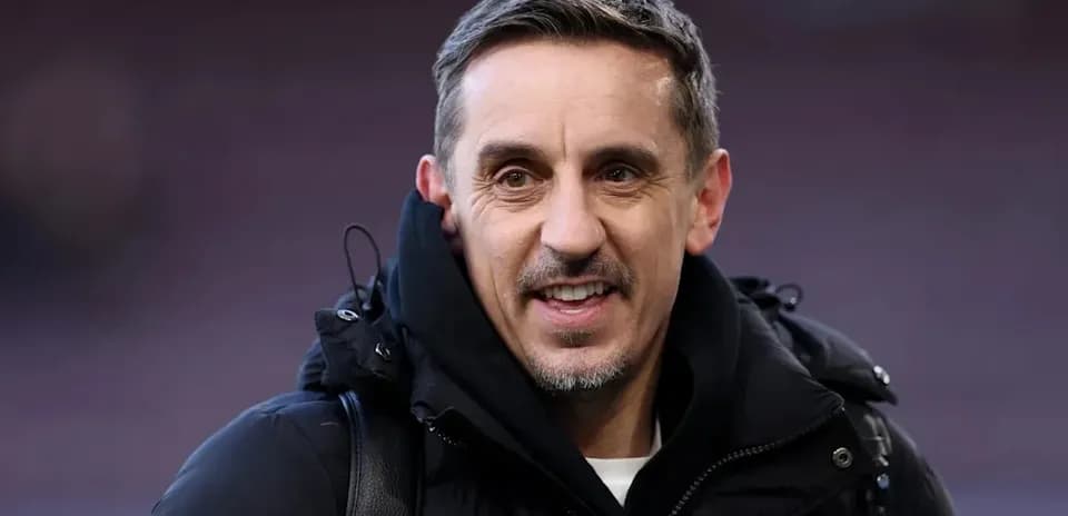 Man in black coat smiling at the camera