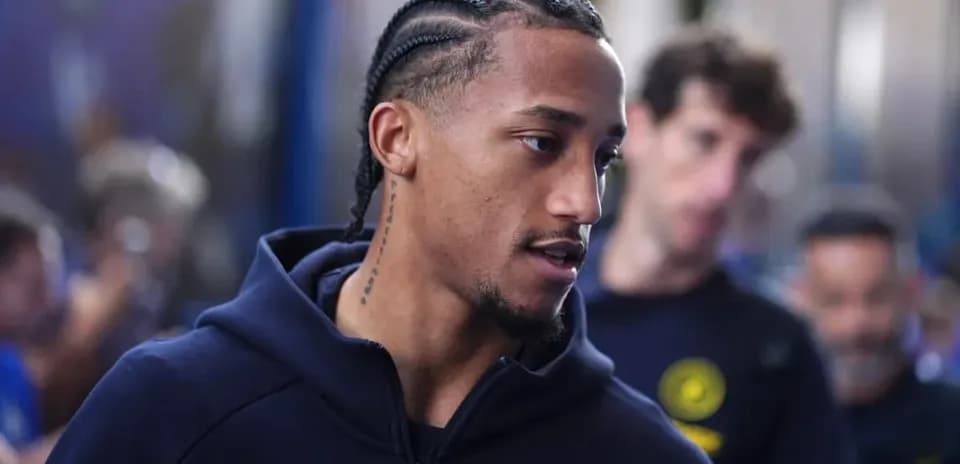 Player with braided hair walking in team apparel