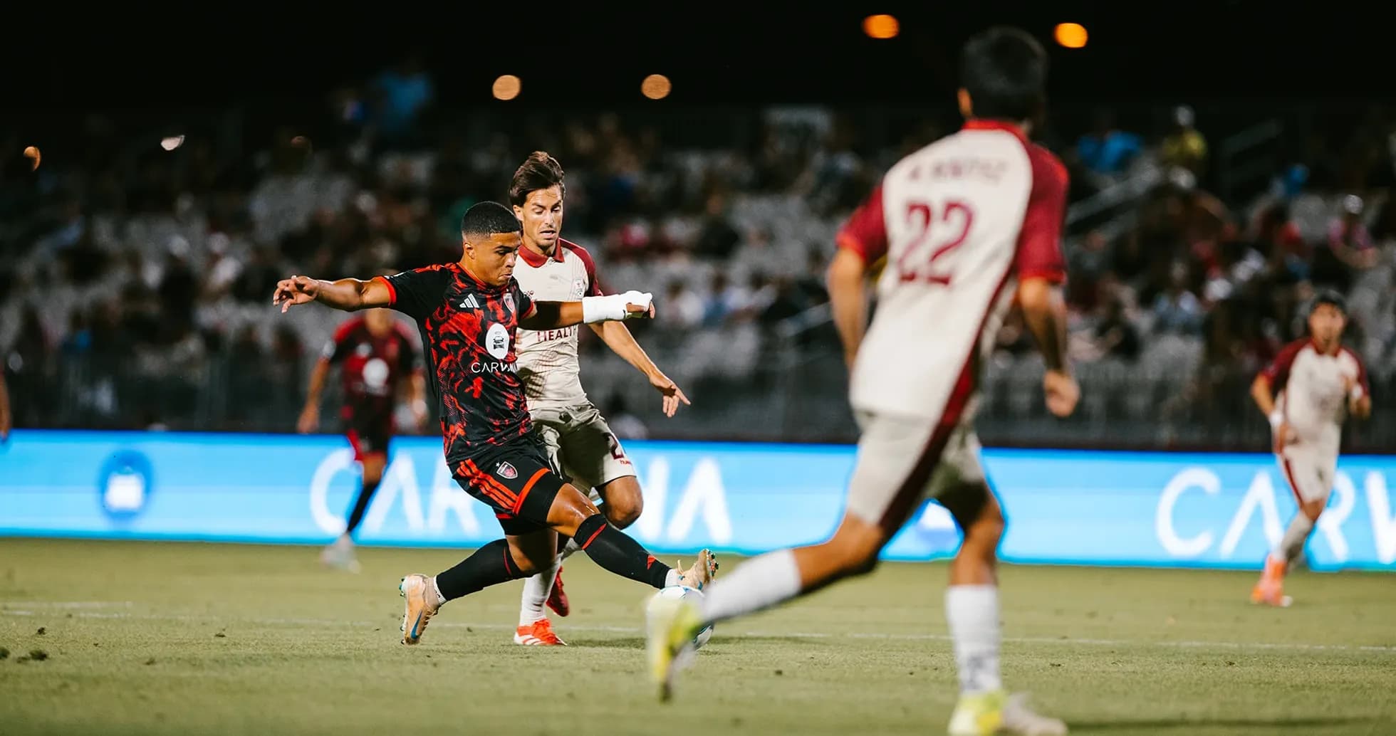 Phoenix Rising player kicking the ball against Sacramento