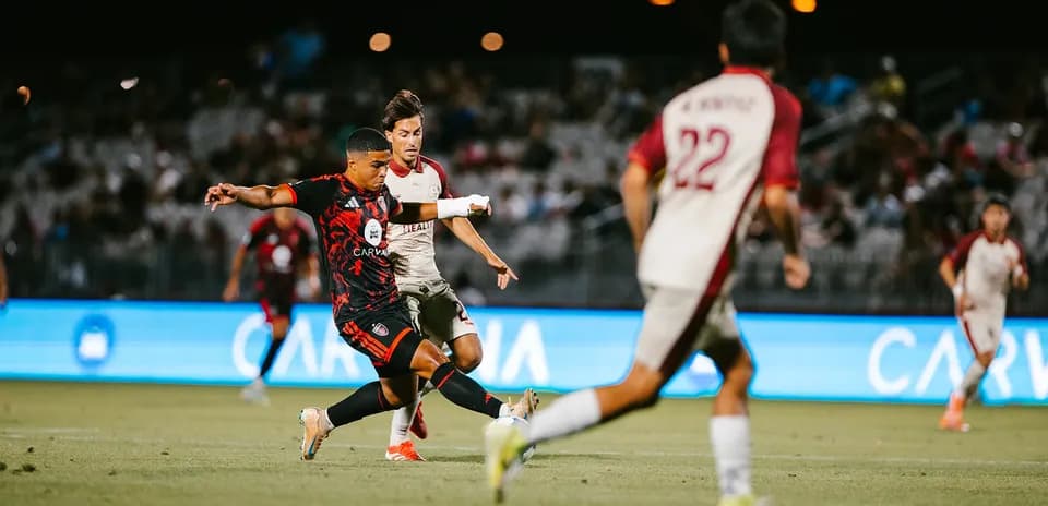 Phoenix Rising player kicking the ball against Sacramento