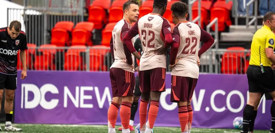 Players discussing strategy during USL Championship match