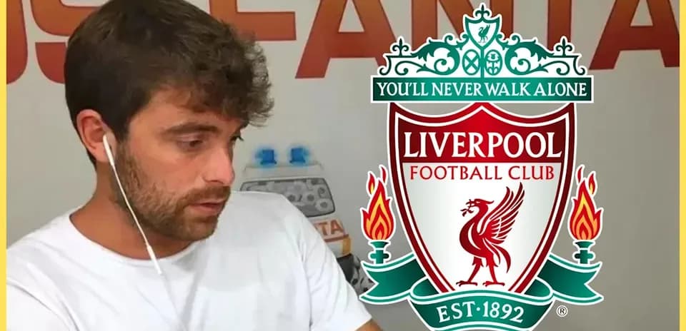 Person wearing headphones with Liverpool FC logo