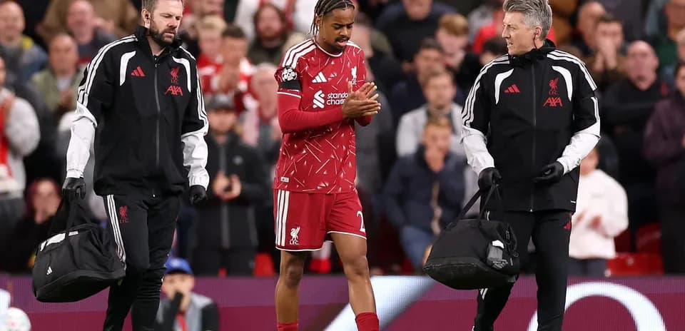Liverpool player receiving assistance from medical staff