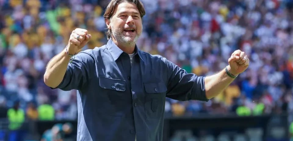 Coach celebrating during a match at stadium